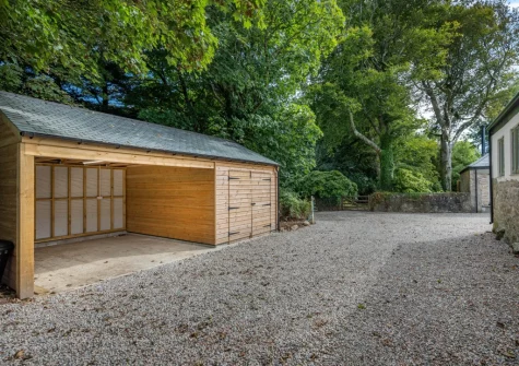 The large garage with secure space for storing kayaks, paddleboards, bicycles & beach kit