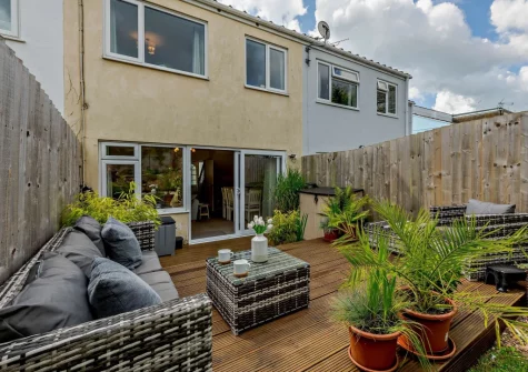 The rear enclosed garden with decked patio & outdoor sitting area at The Chimes, Brixham