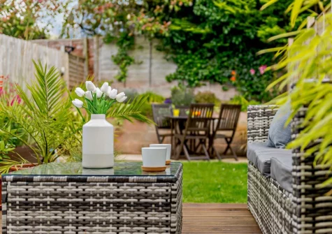 The rear enclosed garden with decked patio & outdoor sitting area at The Chimes, Brixham