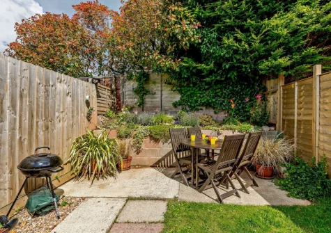 The rear enclosed garden with barebcue & alfresco dining area at The Chimes, Brixham