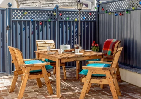 The enclosed courtyard garden, barbecue & alfresco dining area at The Coach House at Kilbroney, Week St Mary