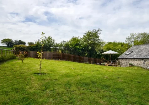 The dog friendly enclosed garden at The Coach House, Whiddon Down