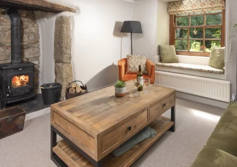 The Corner Cottage, Carnhell Green is a romantic 17th-century retreat for two, boasting a private hot tub, wood burning stove and rustic charm, plus a shared heated pool and easy access to Cornwall's finest coastal treasures, dogs welcome too.