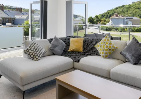 The Cube, Portreath, is a stylish two-bedroom house just a ten-minute stroll from a golden sandy beach. Enjoy a wrap-around sun balcony, a games room with pool table, and easy access to Cornwall's north-coast charms, perfect for families and couples.