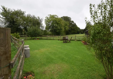 The alfresco dining area & enclosed lawned garden at The Dairy, Aylesbeare