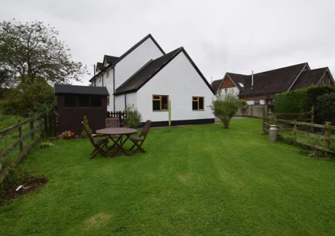 The alfresco dining area & enclosed lawned garden at The Dairy, Aylesbeare