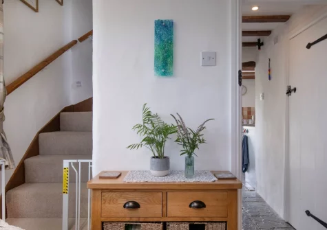 The living room & stairs up to the first floor at The Dairy Barn, Sutcombe