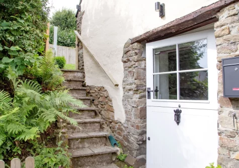 Head up the granite steps to the enclosed garden at The Dairy Barn, Sutcombe