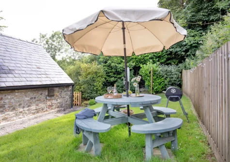 The enclosed garden, barbecue & alfresco dining area at The Dairy Barn, Sutcombe