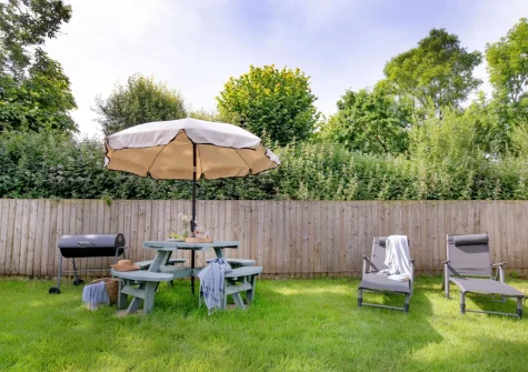 The garden, barbecue & alfresco dining area at The Dairy Barn, Sutcombe