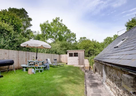 The garden, barbecue & alfresco dining area at The Dairy Barn, Sutcombe