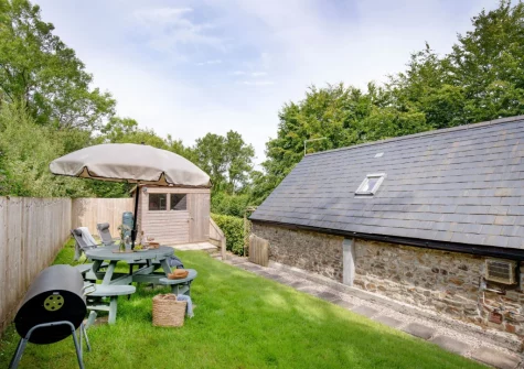 The garden, barbecue & alfresco dining area at The Dairy Barn, Sutcombe