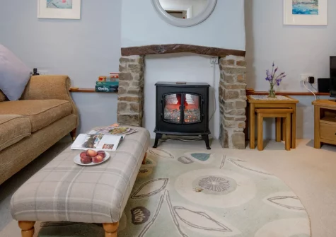 The Dairy Barn, Sutcombe is a charming two-bedroom barn conversion sleeping four, set down a quiet Devon lane, offering cosy interiors, a peaceful garden with valley views, and easy access to the beaches and attractions of Devon and Cornwall.