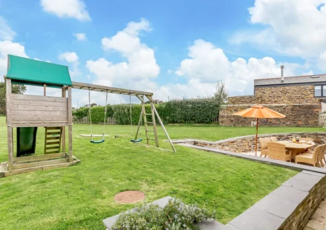 The children's play area & large enclosed garden at The Dreyhouse, St Issey