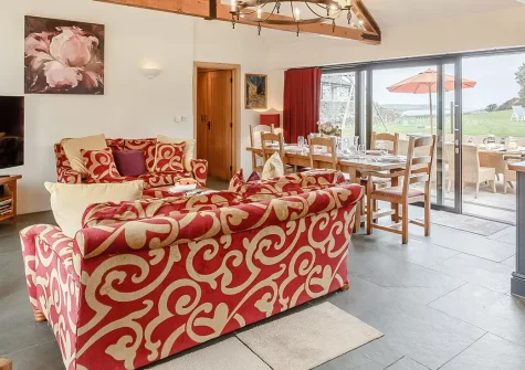 The Dreyhouse, St Issey is a light-filled barn conversion brimming with charm and appeal. Enjoy glorious countryside views, a children's play area, and easy access to North Cornwall's beaches and attractions—perfect for unforgettable family holidays.