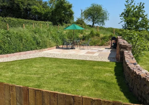 The enclosed patio, barbecue, alfresco dining area & lawned garden at The East Linhay, Leigh Town, Loxbeare
