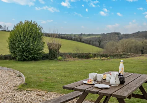 The patio, alfresco dining area & garden at The Farmhouse, Spirewell Farm, Wembury