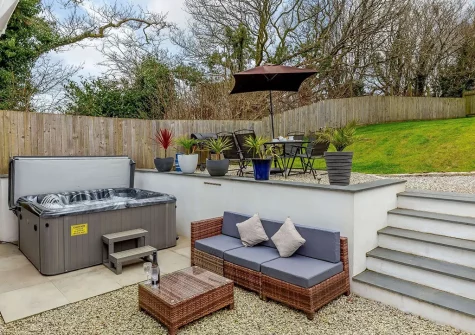 The patio, outdoor sitting area & hot tub at The Fox's Den, Darite