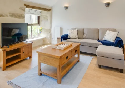 The Gables, Porthleven is a charming one-bedroom apartment in a bustling harbour town, with a sunny patio, exposed stone walls, original wooden beams and coastal styling, just half a mile from the beach, perfect for a romantic Cornish getaway.