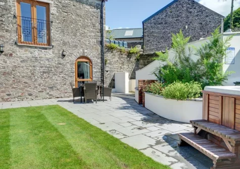 The patio, alfresco dining area, hot tub & garden at The Granary, Muddiford