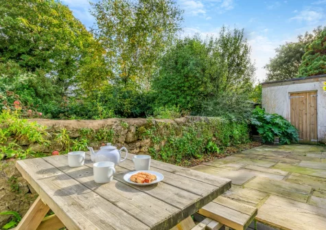 The patio garden, alfresco dining area & outdoor storeroom at The Haven, Branscombe