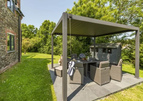 The pergola-covered patio, barbecue & alfresco dining area at The Hawthorns at Roserrow, Polzeath
