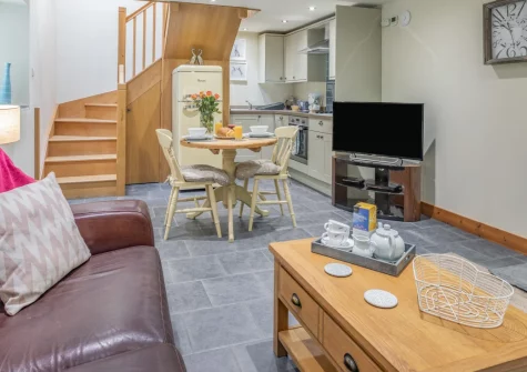 The Hayloft, Dunmere is a cosy stone barn conversion for two, featuring slate floors, a crackling wood burner and a private patio, set amid Cornwall's countryside near Bodmin Moor, the Eden Project and the River Camel's fishing waters, ideal for two.