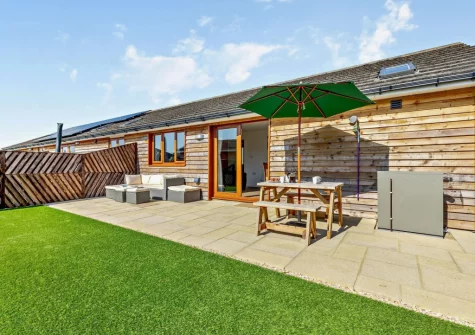 The patio, outdoor sitting, alfresco dining area & garden at The Hive Retreat, Tytherleigh