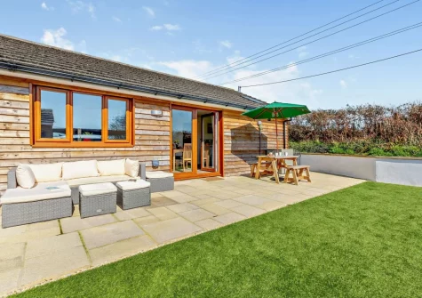 The patio, outdoor sitting, alfresco dining area & garden at The Hive Retreat, Tytherleigh
