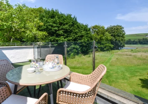 The balcony, barbecue & alfresco dining area at The Holt at Pillmouth Farm, Landcross