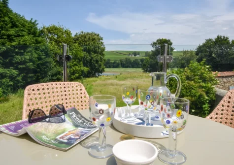 The balcony, barbecue & alfresco dining area at The Holt at Pillmouth Farm, Landcross