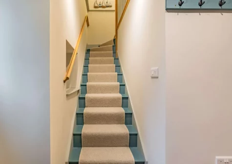 The stairs down from the first floor at The Holt at Pillmouth Farm, Landcross