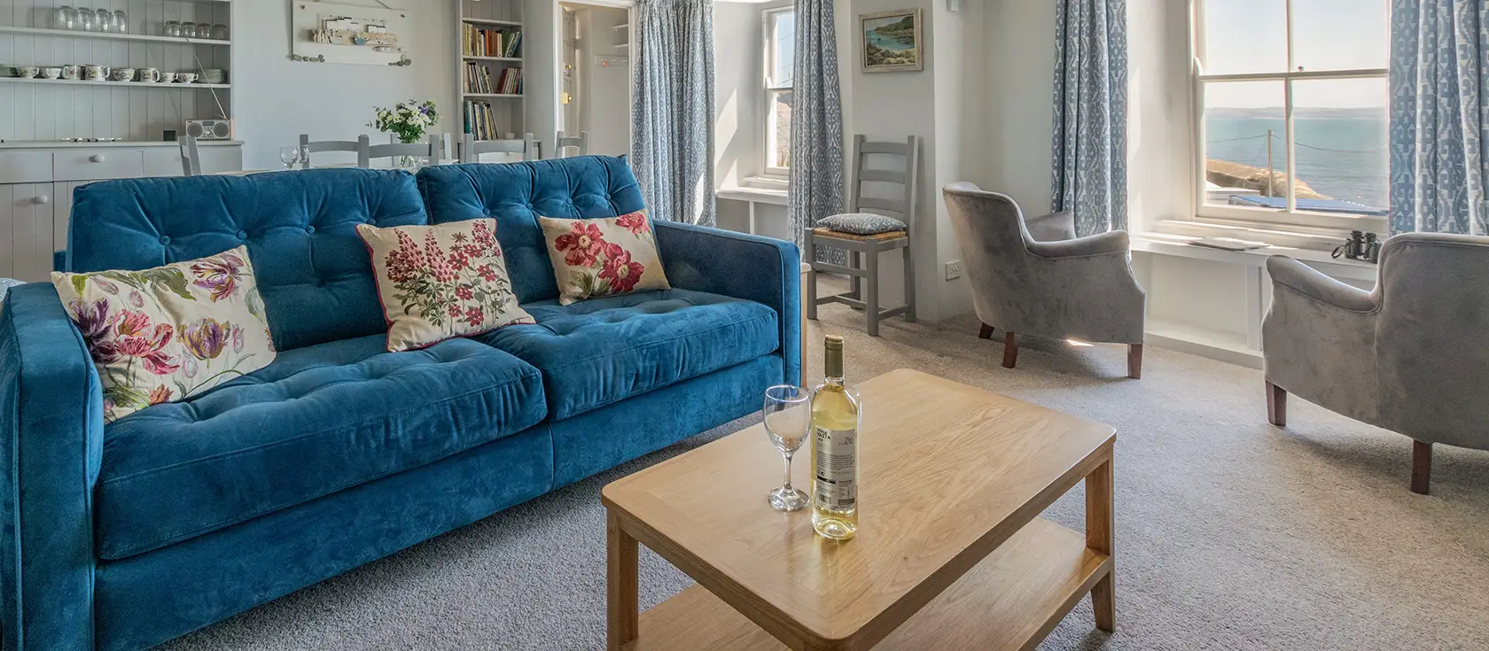 The Kellan, Mousehole is a characterful five-bedroom cottage wrapped around a private suntrap courtyard. Features include a remarkable library with baby grand piano, traditional Aga kitchen, and stunning sea views. Perfect literary retreat.