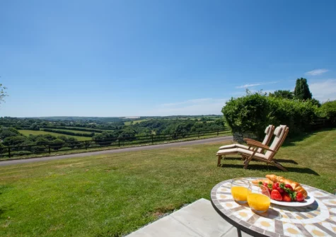 The patio, barbecue, outdoor sitting area & lawned garden at The Linney at Penrose Burden, St Breward