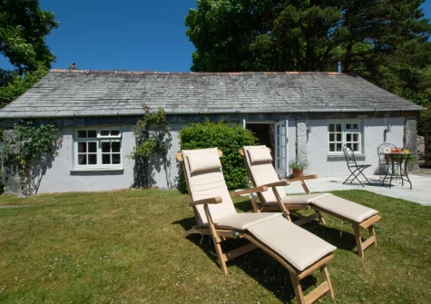 The patio, barbecue, outdoor sitting area & lawned garden at The Linney at Penrose Burden, St Breward