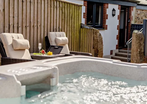The outdoor sitting area & hot tub at The Loggin, Trebudannon