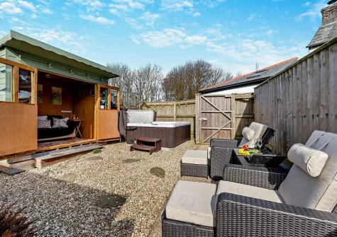 The outdoor sitting area, hot tub & summerhouse at The Loggin, Trebudannon