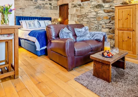 The Loggin, Trebudannon is a studio-style barn conversion blending period features with modern luxury. With a private hot tub, summerhouse, and cosy wood burner, it offers tranquil seclusion & easy access to Cornwall's finest beaches & attractions.