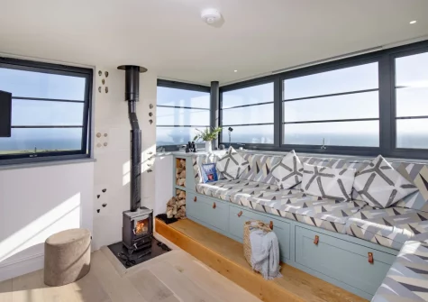 The living room, seating sits atop a platform to make the most of the exceptional views, at The Lookout Tower, Beer