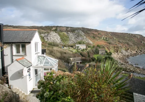 The Magazine is a pretty cottage with a tiered garden set on the hillside above the sea in Lamorna Cove