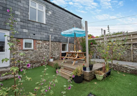The decked patio, alfresco dining area & garden at The Martyn Rooms, Morwenstow