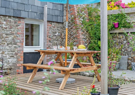 The decked patio, alfresco dining area & garden at The Martyn Rooms, Morwenstow