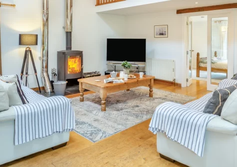 The Moohey, Downderry is a stunning four-bedroom barn conversion blending 200-year-old character with stylish interiors, a games room, and enclosed gardens with sea views, just one mile from the beach in beautiful South East Cornwall.