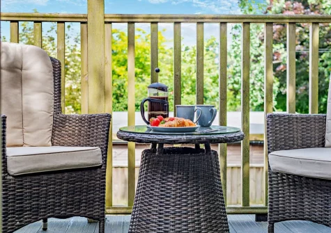 The balcony & outdoor sitting area at The Nook, Trebudannon