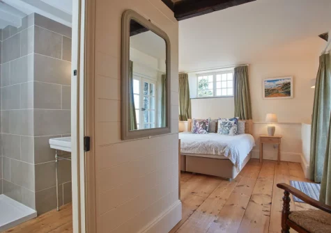 The bedroom & en-suite shower room at The North Wing at Trevigue, Crackington Haven