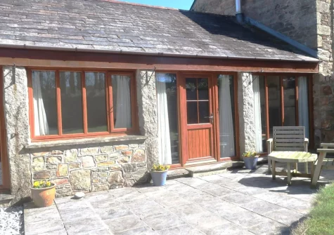 The patio, outdoor sitting area & enclosed garden at The Old Cart House, Lanivet