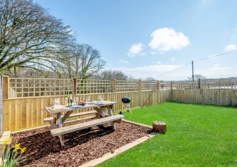 The barbecue, alfresco dining area & enclosed garden at The Old Cattle Shed, Altarnun