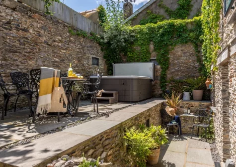 The patio, alfresco dining area & hot tub at The Old Chapel, Brixham