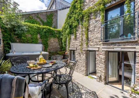 The patio, alfresco dining area & hot tub at The Old Chapel, Brixham