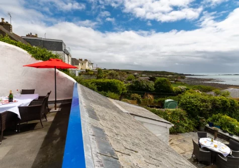 Enjoy sea views from the first-floor balcony & alfresco dining area at The Old Cowshed, Marazion